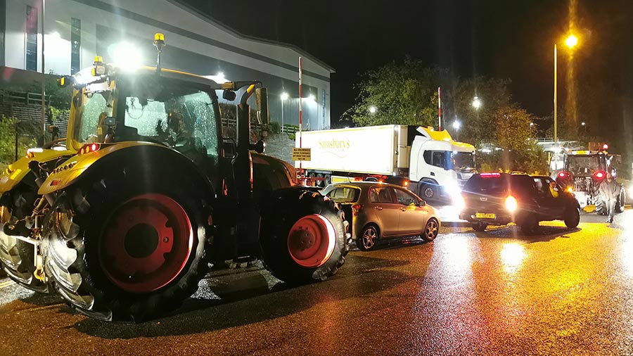 Tractor and cars blocking entrance to Sainsbury's depot